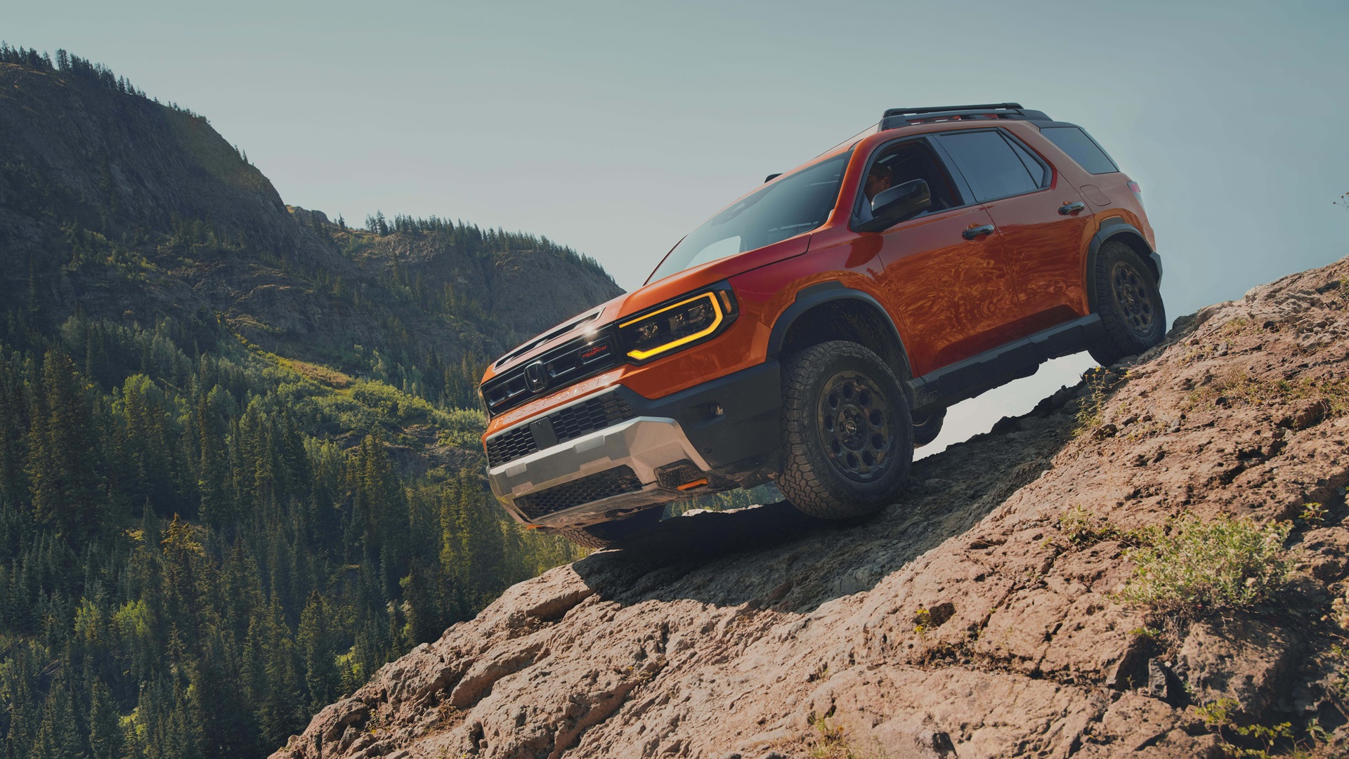 Honda Passport TrailSport Off-Roading The 2026 Honda Passport TrailSport driving on a rocky off-road trail.